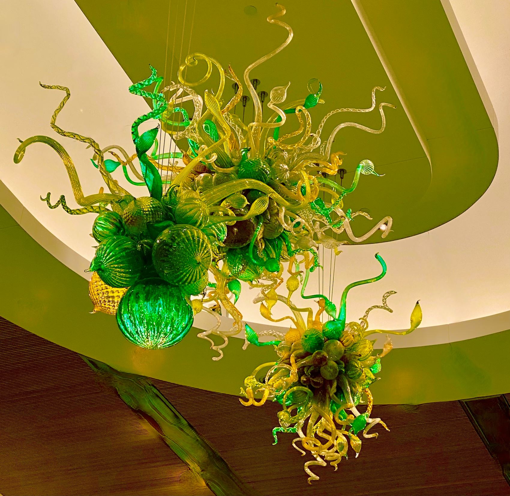 Photograph of Green Sculpture Suspended from Ceiling 