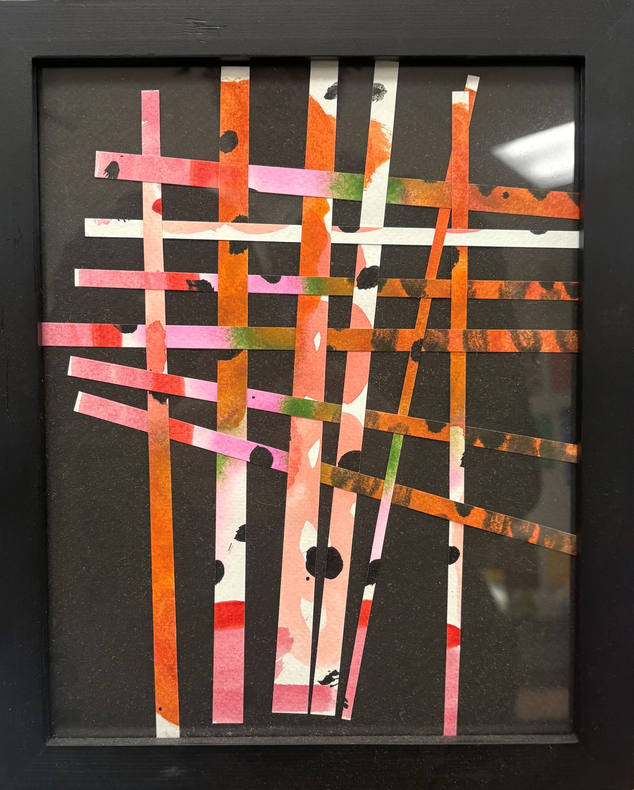 Artwork that features strips of woven paper.