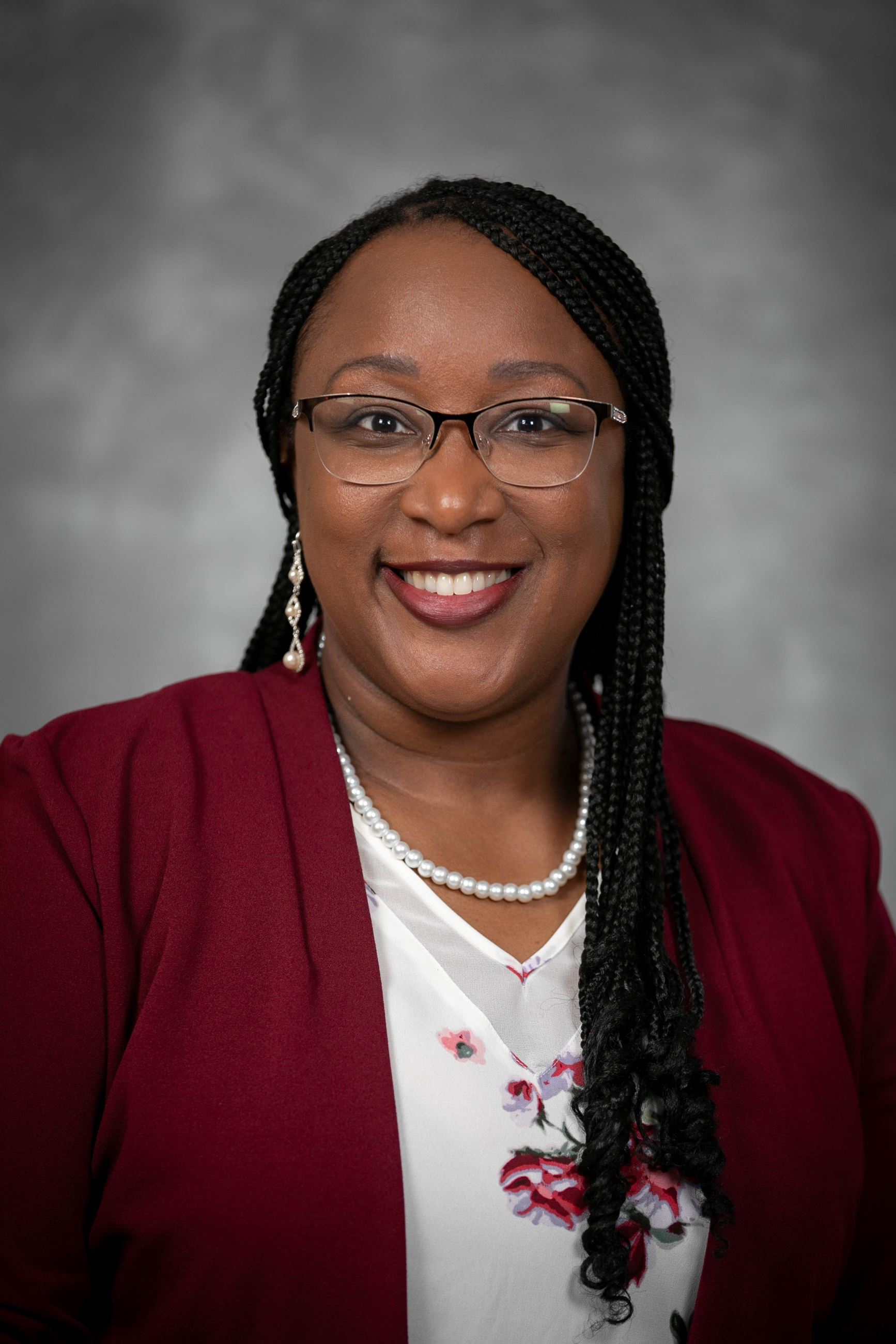 Headshot of a woman in a shirt and a blazer.